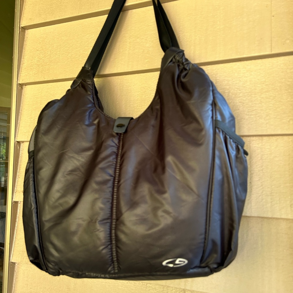 Champion puffer Tote  black with Purplr lining, Zip and snap closure